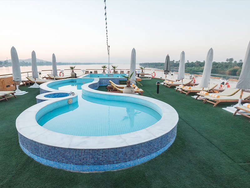 The pool and sun deck of a Nile cruise ship with guests relaxing