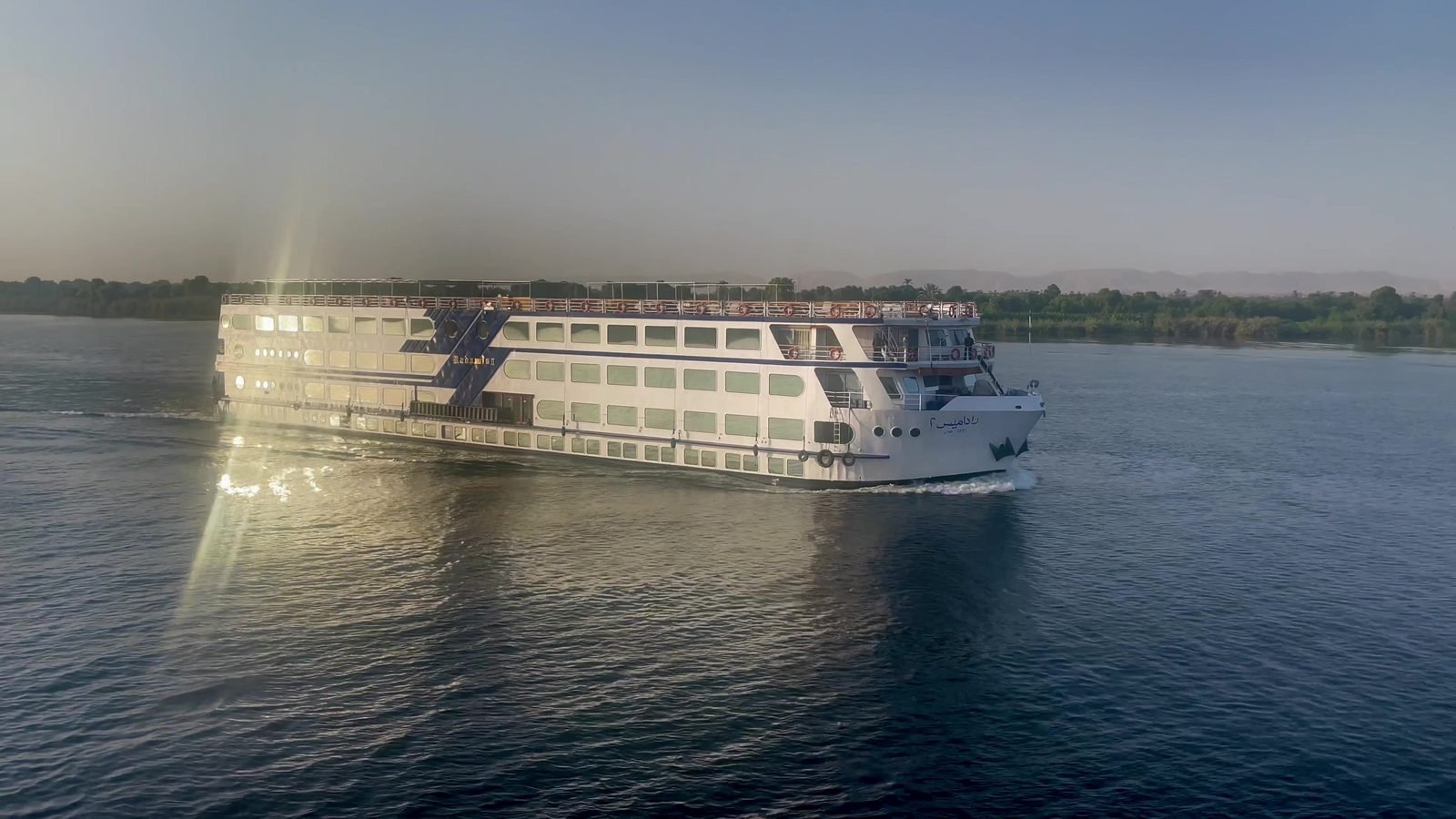 cruise-ship-on-the-nile A Nile cruise ship under way on the river between Luxor and Aswan in the late afternoon light