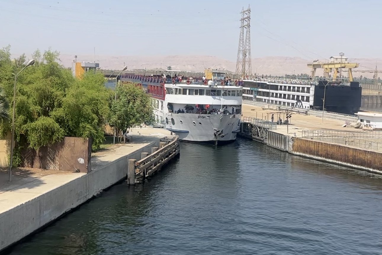 A Nile cruise ship entering the lock at the New Esna Barrage, with another ship in the chamber beside it