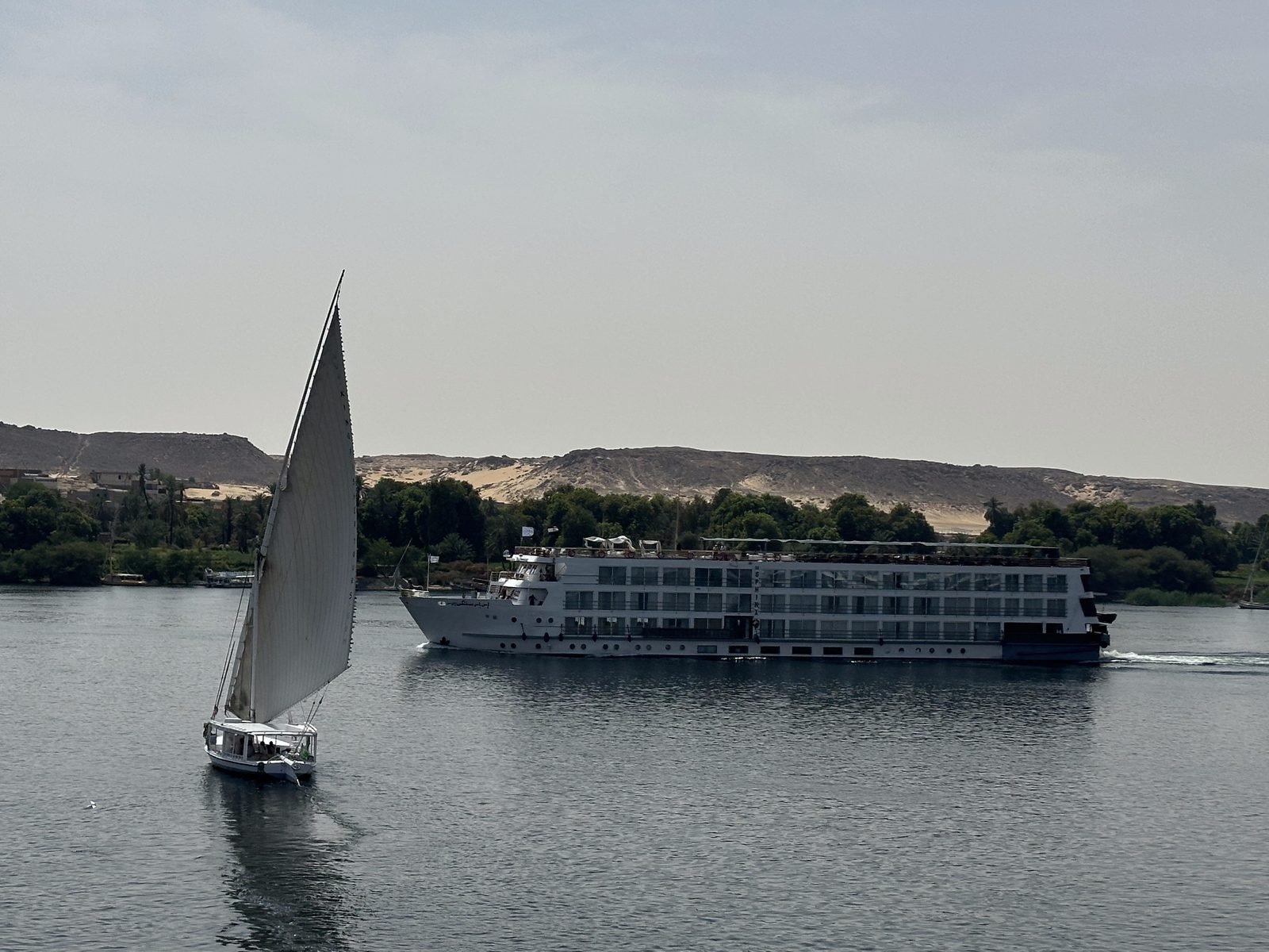 felucca-and-cruise-ship-on-the-nile A felucca sailing past a Nile cruise ship