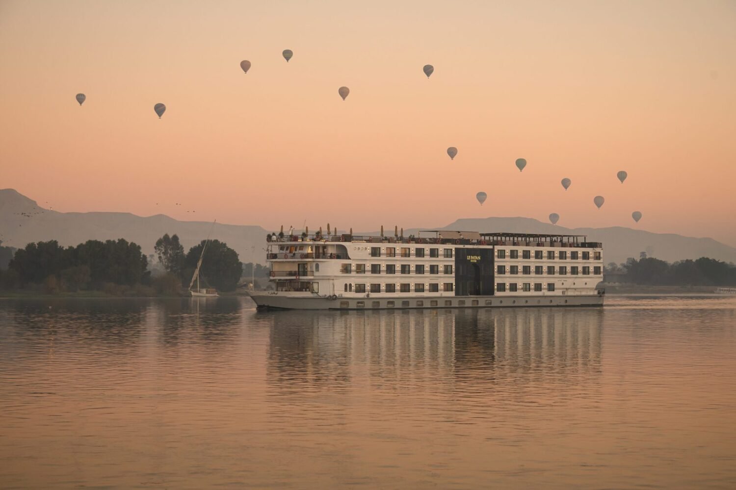 Le Fayan Suites at Luxor with hot-air balloons above the West Bank