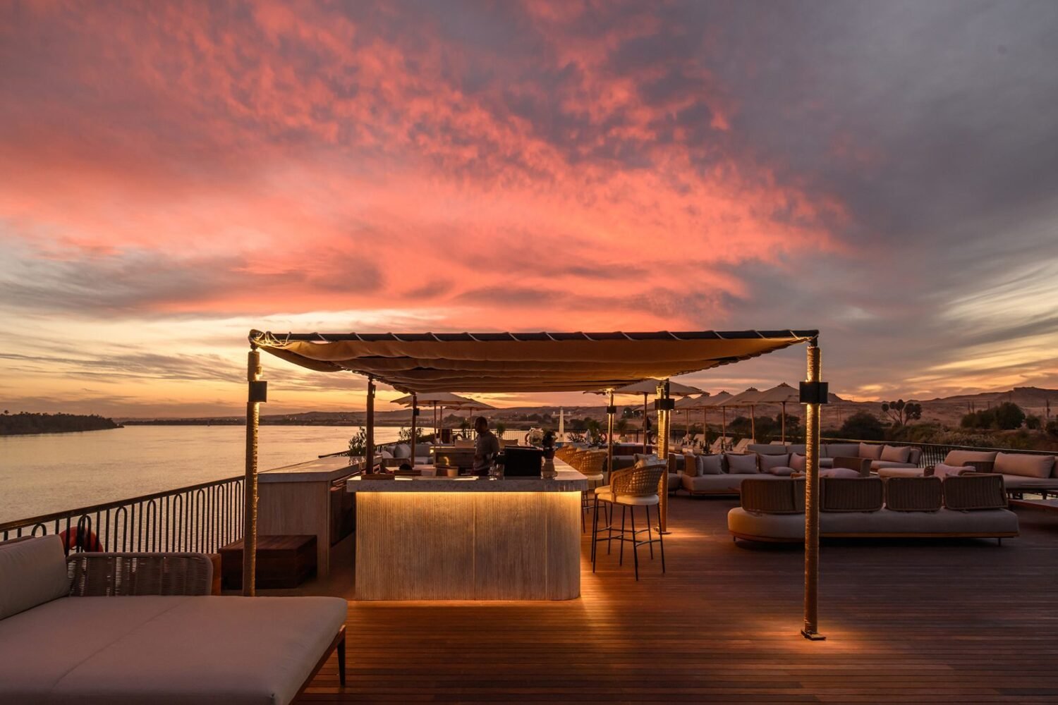 The sundeck bar at dusk on Le Fayan Suites