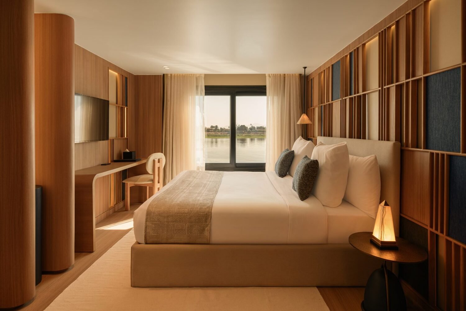 A luxury suite on Le Fayan Suites with a large window on the Nile