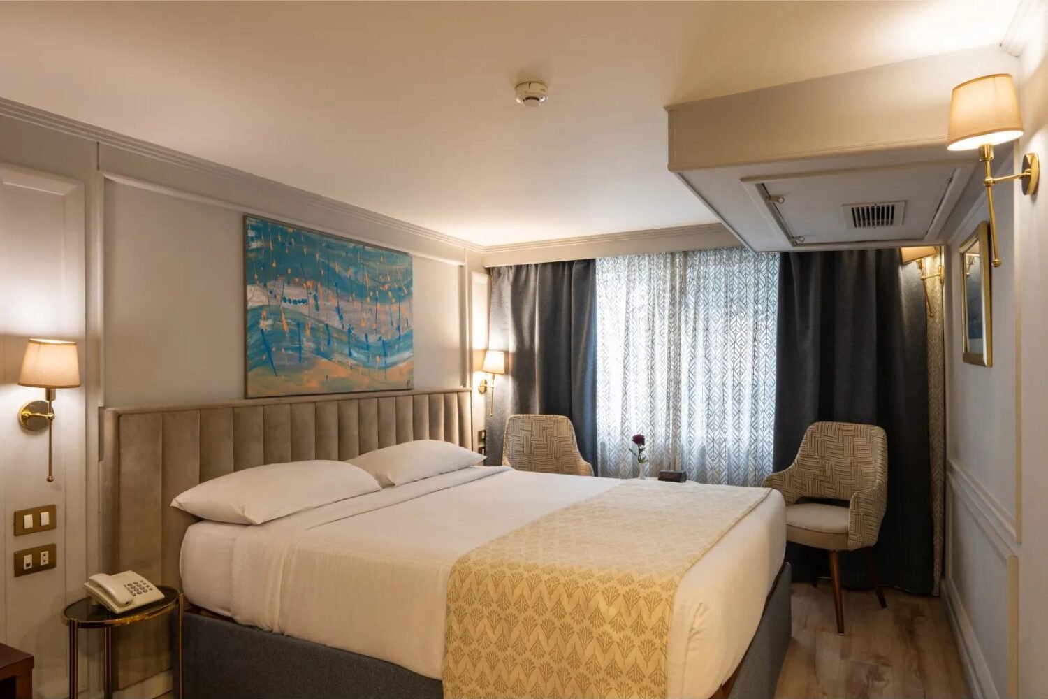 Nile Excellence suite with a large bed and armchairs