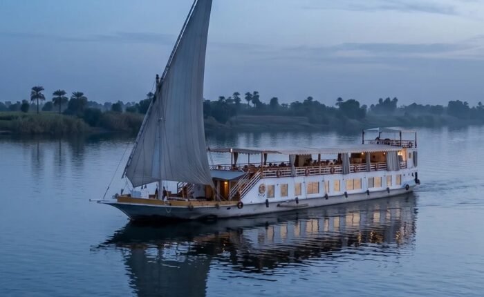 The Swan dahabiya under sail on the Nile at dusk
