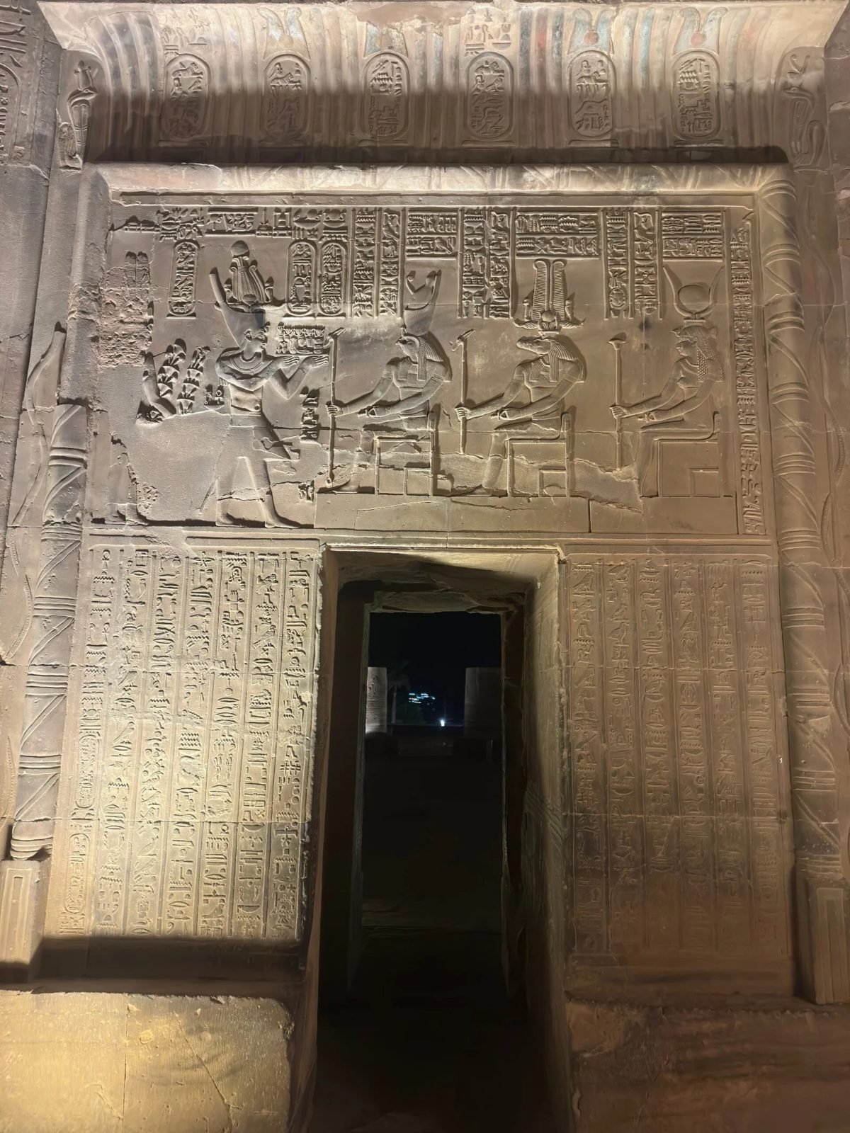 Carved doorway and reliefs of Kom Ombo temple at night during a private visit